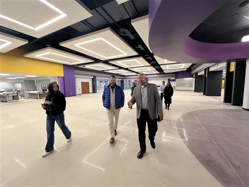  board members walking through open space inside Journey Middle